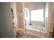 Bathroom featuring a soaking tub, shower, and a large window at 414 Norton Xing, Woodstock, GA 30188