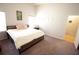 Bedroom featuring a bed with plush pillows, a window, and a door at 414 Norton Xing, Woodstock, GA 30188