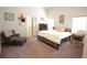 Spacious bedroom with a sitting area and a comfortable bed and two windows at 414 Norton Xing, Woodstock, GA 30188