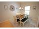 Bright dining room with modern chandelier, long table, bench and a large window at 414 Norton Xing, Woodstock, GA 30188