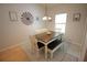 Bright dining room with modern chandelier, long table, bench and a large window at 414 Norton Xing, Woodstock, GA 30188