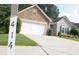 Charming home featuring a stone facade, two-car garage and well manicured lawn at 414 Norton Xing, Woodstock, GA 30188
