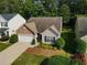 Charming home featuring stone accents, a well-manicured lawn, and a two-car garage at 414 Norton Xing, Woodstock, GA 30188