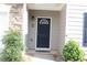 Inviting front door with dark color and decorative details at 414 Norton Xing, Woodstock, GA 30188