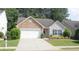 Charming one-story home with stone accents, a two-car garage, and a well-manicured lawn at 414 Norton Xing, Woodstock, GA 30188