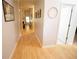 Light-filled hallway showcasing hardwood floors and decorative wall art at 414 Norton Xing, Woodstock, GA 30188
