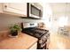 Kitchen features stainless steel appliances and countertops at 414 Norton Xing, Woodstock, GA 30188