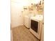 Well-lit laundry room with modern washer and dryer, plus storage shelves at 414 Norton Xing, Woodstock, GA 30188
