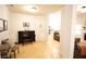 An open concept living room features a piano, light hardwood floors, and white walls at 414 Norton Xing, Woodstock, GA 30188
