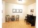 Living room showcasing a piano, light hardwood floors, and white walls and trim at 414 Norton Xing, Woodstock, GA 30188