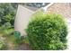 The side of the home with vinyl siding and surrounded by landscaping at 414 Norton Xing, Woodstock, GA 30188