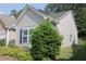 Side view of the home with vinyl siding and well-maintained shrubbery at 414 Norton Xing, Woodstock, GA 30188