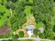 An aerial view of a residence showcases a stunning property with mature trees, water feature, and a long driveway at 4829 Moon Rd, Powder Springs, GA 30127
