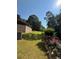 Lush backyard featuring vibrant azalea bushes, well-maintained lawn, and partial privacy wall at 4829 Moon Rd, Powder Springs, GA 30127