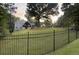 Secluded home with a large yard and classic black fence for privacy and security at 4829 Moon Rd, Powder Springs, GA 30127