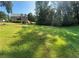 Spacious backyard featuring a lush lawn with mature trees and a view of the home's exterior at 4829 Moon Rd, Powder Springs, GA 30127