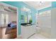Bathroom with modern blue walls, vanity with black countertop, and a tub/shower combo at 4829 Moon Rd, Powder Springs, GA 30127