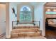 Soaking tub with steps and a large window for natural light in the main bathroom at 4829 Moon Rd, Powder Springs, GA 30127
