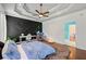 Bedroom featuring a custom panel wall, tray ceiling and walk-in closet at 4829 Moon Rd, Powder Springs, GA 30127