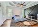 Bedroom featuring a custom panel wall, tray ceiling and walk-in closet at 4829 Moon Rd, Powder Springs, GA 30127