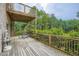 A spacious outdoor deck offers a relaxing retreat with wood flooring, views of lush trees, and a peaceful atmosphere at 4829 Moon Rd, Powder Springs, GA 30127