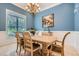 Dining room featuring blue walls, chandelier, and large window at 4829 Moon Rd, Powder Springs, GA 30127