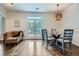 Bright dining room with glass table and outdoor access through french doors at 4829 Moon Rd, Powder Springs, GA 30127