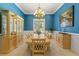 Dining room featuring blue walls, chandelier, and large window at 4829 Moon Rd, Powder Springs, GA 30127