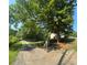 Long, gravel driveway bordered by trees, leading to an estate with a gated entrance at 4829 Moon Rd, Powder Springs, GA 30127