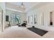 Bright exercise room with an elliptical machine, mirrors, and large windows for natural light at 4829 Moon Rd, Powder Springs, GA 30127