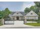 Charming brick home featuring an open gate with manicured landscaping, and an elegant, arched double-door entrance at 4829 Moon Rd, Powder Springs, GA 30127