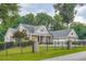 Lovely brick home featuring manicured landscaping, an attached two-car garage, and an elegant, gated entrance at 4829 Moon Rd, Powder Springs, GA 30127
