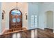Impressive foyer featuring hardwood floors and an arched front door with glass inserts and transom at 4829 Moon Rd, Powder Springs, GA 30127