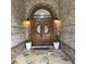 Elegant front entryway with a custom wood double door and stone accents at 4829 Moon Rd, Powder Springs, GA 30127