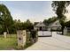 Beautiful brick home with a black iron gate, manicured lawn, and mature trees at 4829 Moon Rd, Powder Springs, GA 30127