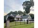 Charming brick home features a well-manicured front yard and a black wrought iron fence at 4829 Moon Rd, Powder Springs, GA 30127