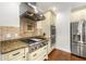 This modern kitchen has stainless appliances, double ovens, custom cabinets, and granite countertops at 4829 Moon Rd, Powder Springs, GA 30127