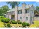Rear view of a brick home with a balcony, showing well-maintained landscaping at 4829 Moon Rd, Powder Springs, GA 30127