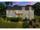 Evening view of the home's exterior with a spacious deck, and manicured landscaping at 4829 Moon Rd, Powder Springs, GA 30127