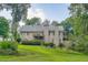 Back of home featuring a stone facade, a deck on the second level, and well-maintained landscaping at 4829 Moon Rd, Powder Springs, GA 30127