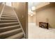 Carpeted stairway with white risers leading to an open area with neutral walls and lighting at 4829 Moon Rd, Powder Springs, GA 30127