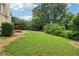 Spacious backyard with lush green grass and mature trees, perfect for outdoor activities at 9744 Spyglass Dr, Villa Rica, GA 30180