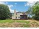 Expansive backyard featuring a screened in porch, mature trees, and ample space for outdoor activities and relaxation at 9744 Spyglass Dr, Villa Rica, GA 30180