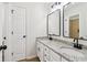 Bright bathroom features double sinks, granite countertops, modern fixtures and tile flooring at 9744 Spyglass Dr, Villa Rica, GA 30180