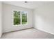 Carpeted bedroom with large window providing outside views at 9744 Spyglass Dr, Villa Rica, GA 30180