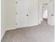 Spacious bedroom featuring neutral carpeting and a traditional panel door at 9744 Spyglass Dr, Villa Rica, GA 30180