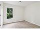 A minimalist bedroom featuring neutral carpet, a window and fresh, white paint at 9744 Spyglass Dr, Villa Rica, GA 30180