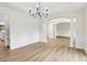 Open dining room with wood floors, wainscoting, and arched doorways at 9744 Spyglass Dr, Villa Rica, GA 30180