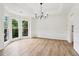 Bright dining room with bay window, chandelier, tray ceiling, and hardwood floors at 9744 Spyglass Dr, Villa Rica, GA 30180