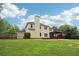 Home's back exterior featuring a screened porch, chimney, and fenced yard at 9744 Spyglass Dr, Villa Rica, GA 30180